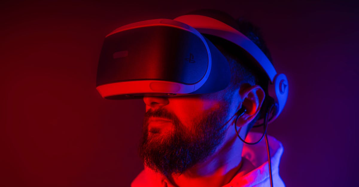Is there a standardized rating system for game difficulty? - Young bearded man entertaining with VR glasses in colorful neon light on black background