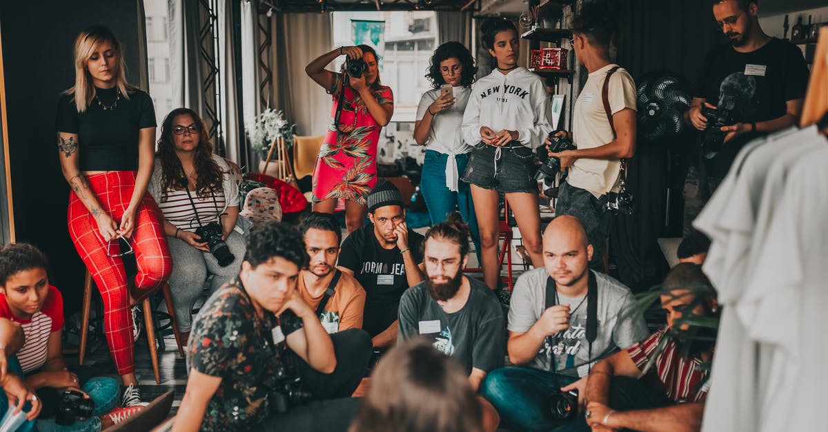Is there a story I should be paying attention to in Dark Souls? - Group of multiracial people wearing casual outfits gathering together in modern studio near female speaker on mat and listening attentively Is there a story I should be paying attention to in Dark Souls? - Group of multiracial people wearing casual outfits gathering together in modern studio near female speaker on mat and listening attentively