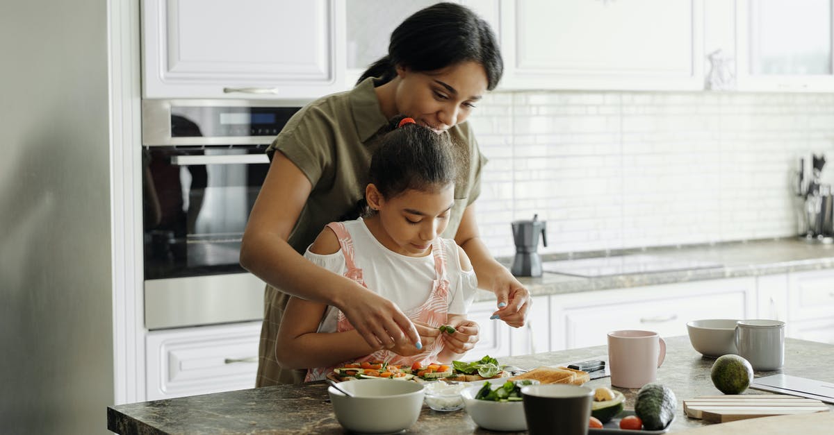 Is there a Thanksgiving hat? - Mother and Daughter Preparing Avocado Toast