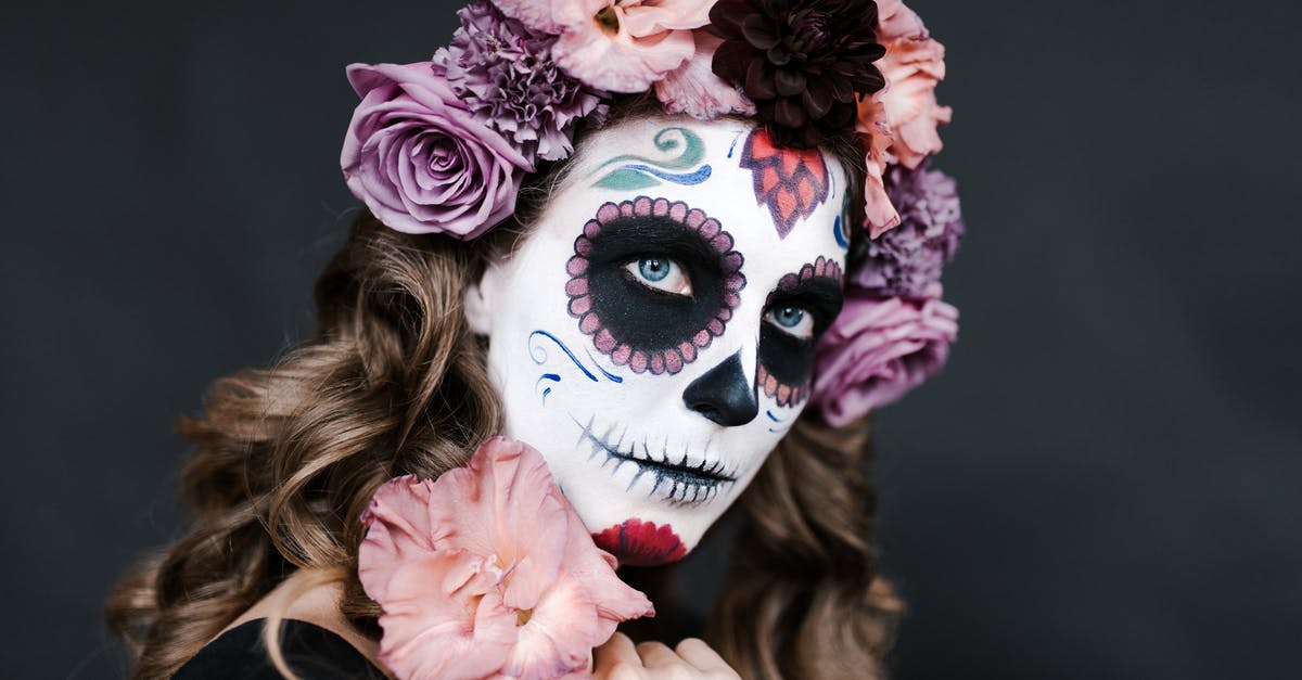Is there a trick to dodging? - Young female with sugar skull make up and hair decorated with flowers for celebrating Halloween
