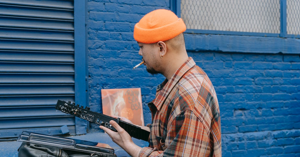 Is there a way that I can stop people from standing still too long? - Man in Orange Knit Cap and Plaid Shirt Playing Black Electric Guitar Is there a way that I can stop people from standing still too long? - Man in Orange Knit Cap and Plaid Shirt Playing Black Electric Guitar