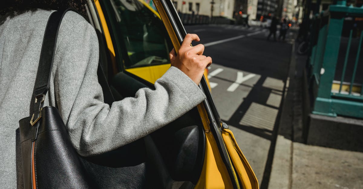 Is there a way to break open this coal door? - Crop ethnic woman opening door of taxi Is there a way to break open this coal door? - Crop ethnic woman opening door of taxi