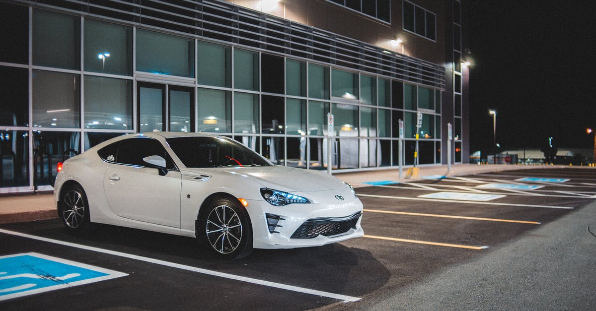 Is there a way to calculate how much Harddrive Space is needed for one's entire Steam Library? [duplicate] - Expensive white automobile on parking space with marking lines near building with glass wall in street at night time