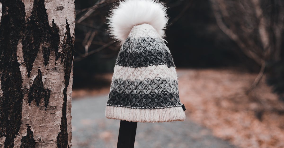 Is there a way to cancel a beam attack on iPad? - Lost and found warm knitted hat placed on metal beam near tree trunk and path with fallen dry leaves in autumn park in daytime