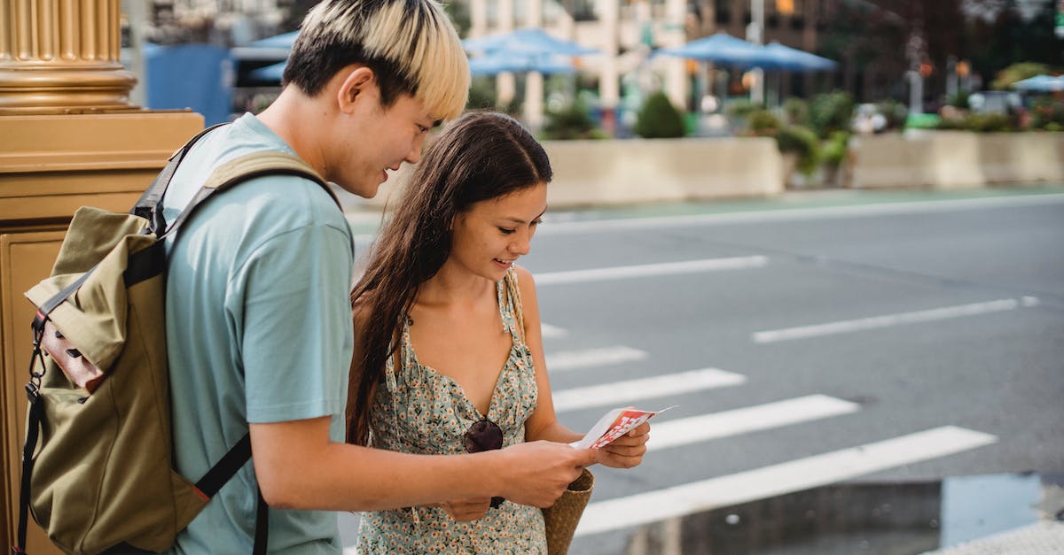 Is there a way to check whether I unlocked the Destiny nameplate? - Traveling couple standing on sidewalk with map