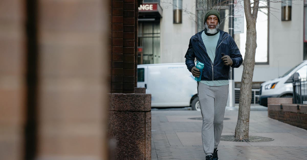 Is there a way to determine character motivations? - Serious African American male jogging on pavement in city Is there a way to determine character motivations? - Serious African American male jogging on pavement in city
