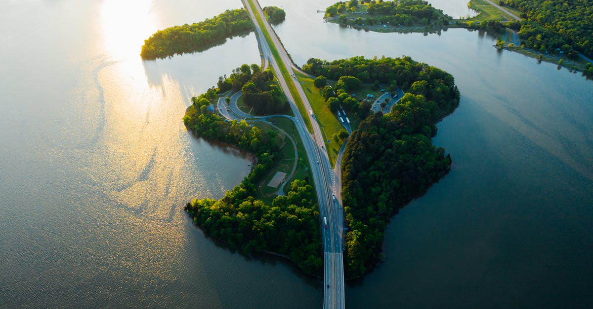 Is there a way to fill with different height water? - Picturesque drone view of road bridge going through green forests and crossing calm lake at sunset Is there a way to fill with different height water? - Picturesque drone view of road bridge going through green forests and crossing calm lake at sunset