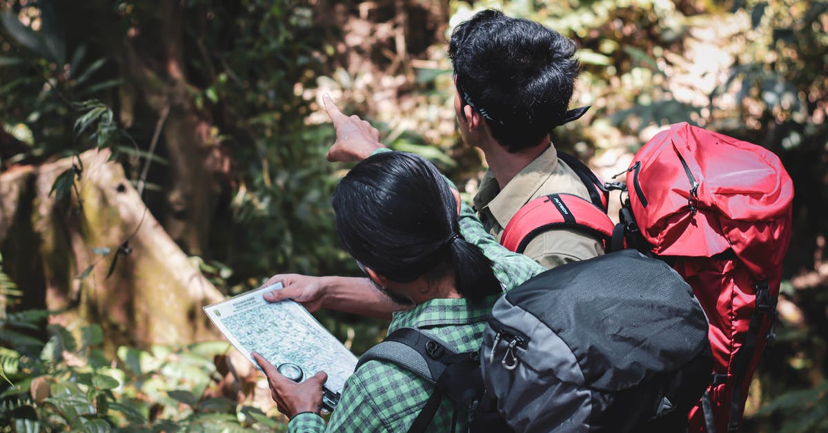 Is there a way to get back to the map once off it in Mine craft? - Male tourists with map standing in forest Is there a way to get back to the map once off it in Mine craft? - Male tourists with map standing in forest
