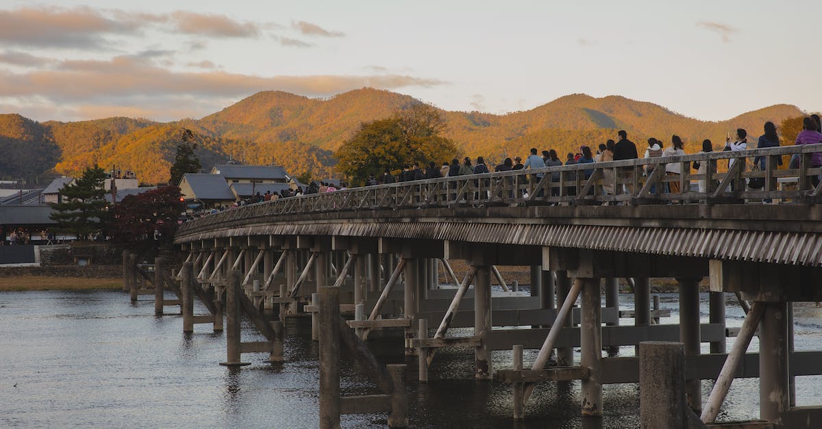 Is there a way to get data out of Age of Empires 3's view postgame? - Anonymous people walking on bridge over river in ancient town at sundown