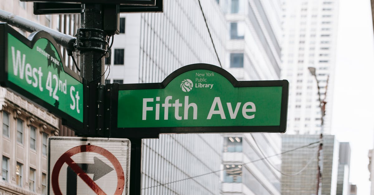 Is there a way to give point to only those who have certain points - Metal post with direction indicator on avenue with high skyscrapers in New York