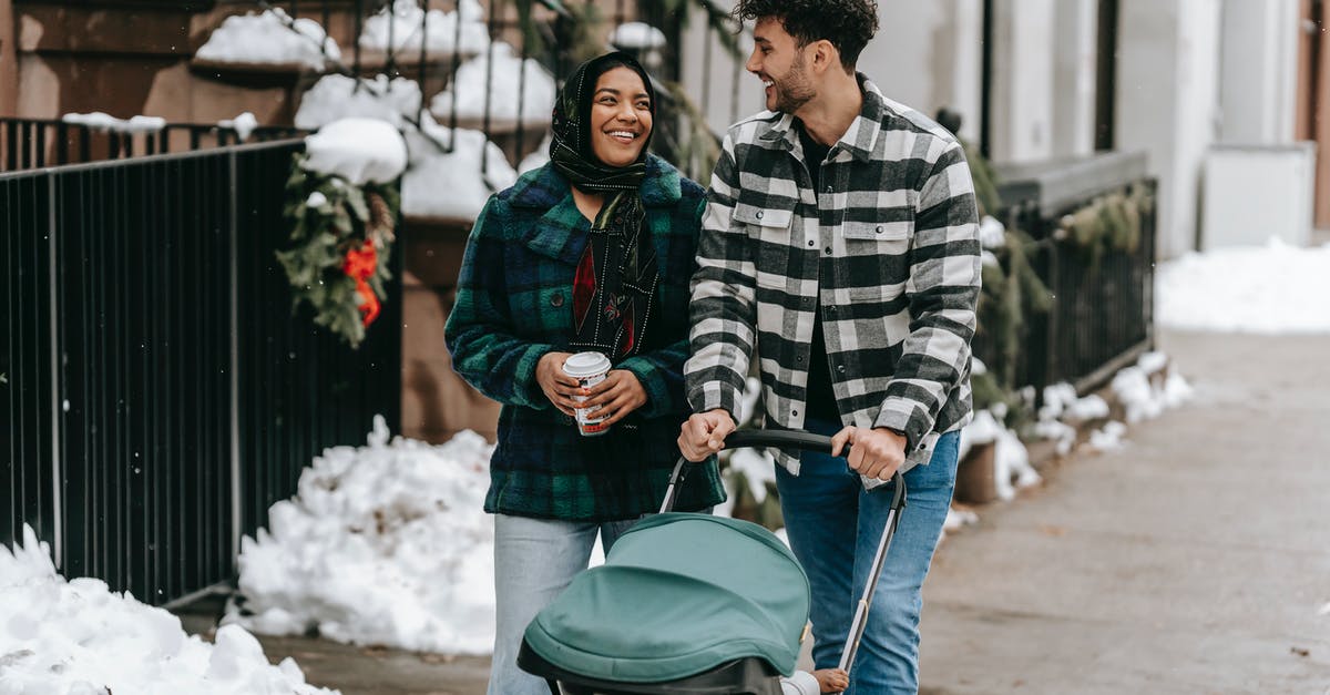 Is there a way to keep the BGM going while paused? - Happy ethnic couple walking with stroller on street in residential city district Is there a way to keep the BGM going while paused? - Happy ethnic couple walking with stroller on street in residential city district
