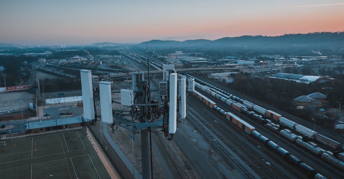 Is there a way to know which VIPs are in my cargo bay? - Cell tower in city suburban area with railroad station at sundown