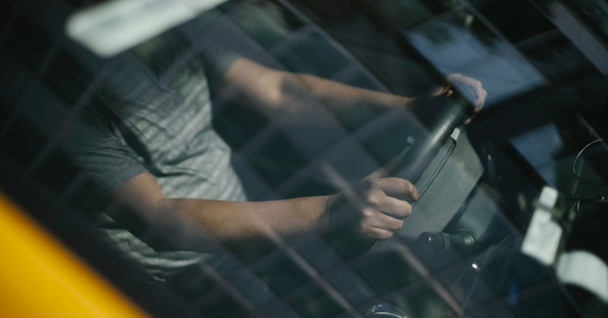 Is there a way to make a kill shooting through a tank window? - Through glass of windshield of ethnic crop male driver in cab while working in city