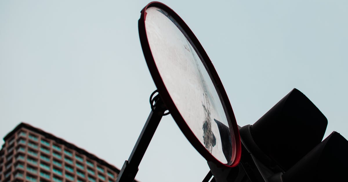Is there a way to make a tourney bracket with more than just 2 combatants per round? - From below round mirror hanging near traffic light against cloudless sky on modern city street
