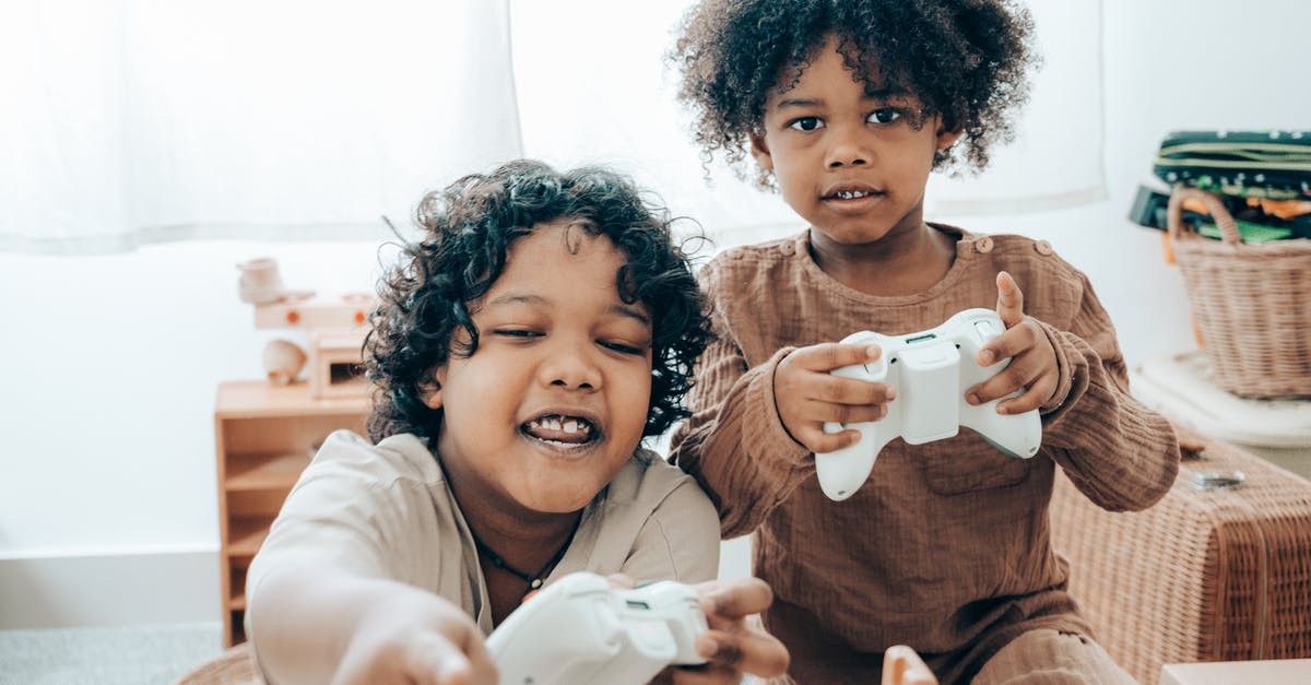 Is there a way to play Minecraft with a friend using "open to LAN" while not on the same network? [duplicate] - Happy African American girls playing video game console at home