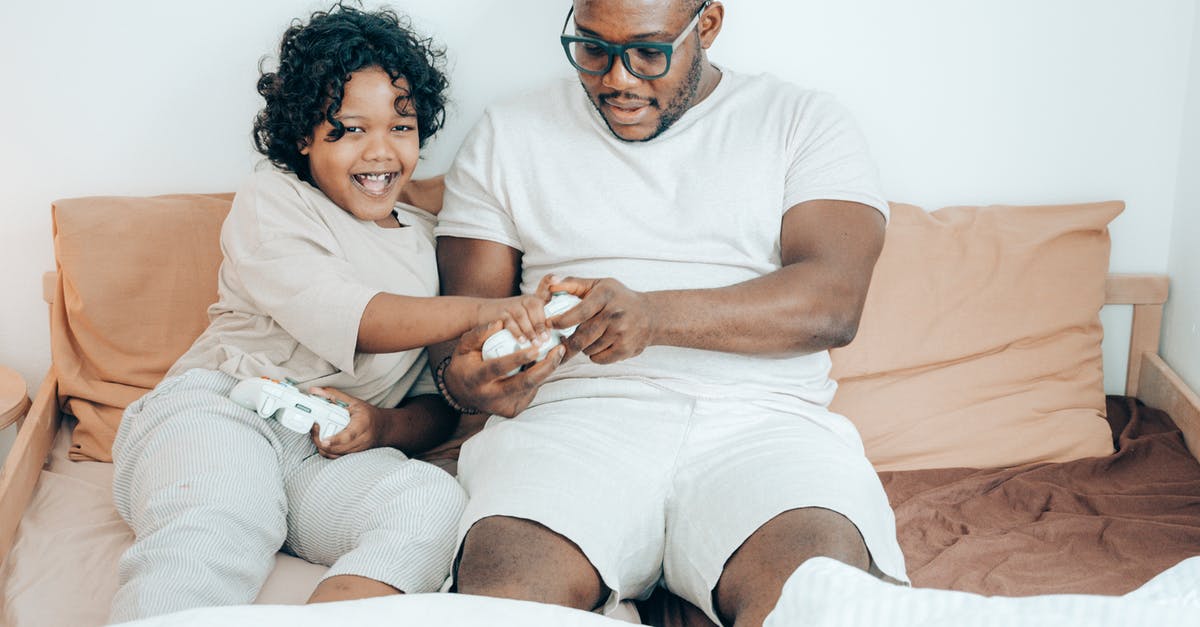 Is there a way to play Minecraft with a friend using "open to LAN" while not on the same network? [duplicate] - Cheerful African American man and child in sleepwear using gamepads while playing together on game console in modern bedroom on morning