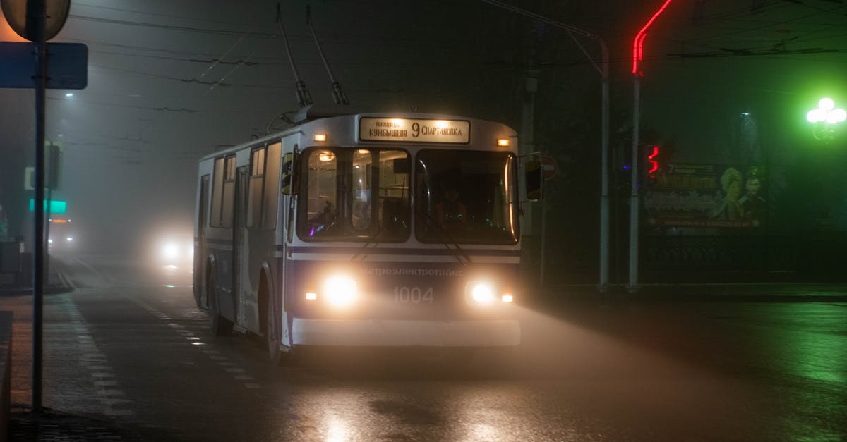 Is there a way to quick move items? - Old trolleybus driving along wet asphalt road in small city at foggy night