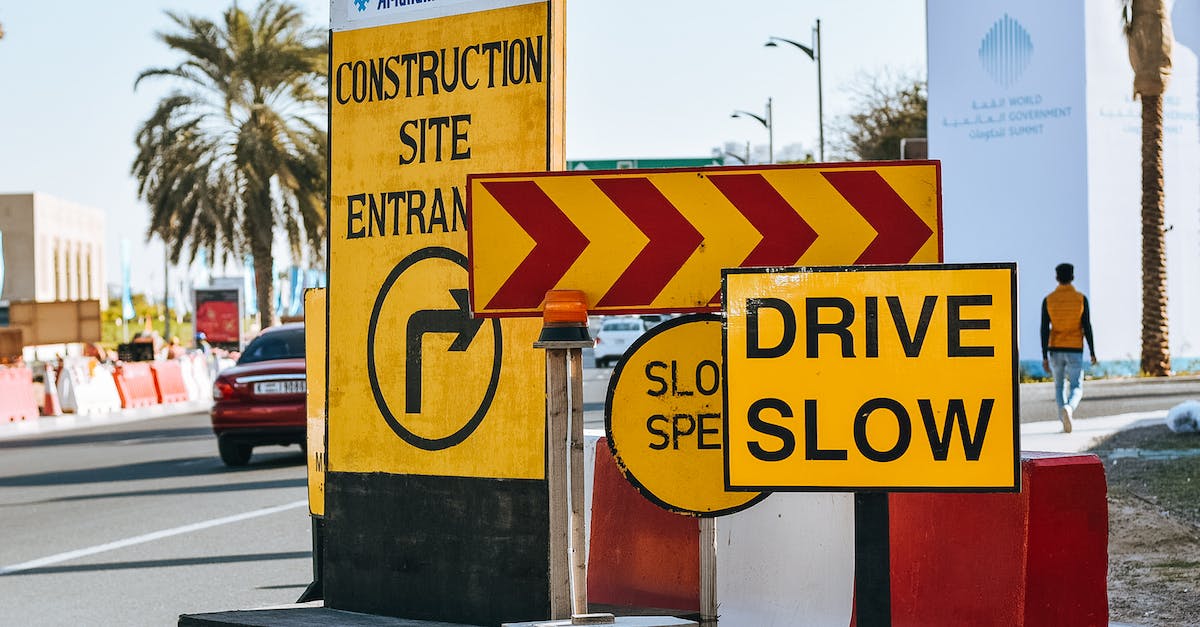 Is there a way to reduce the risk of a disaster? - Contemporary city road on sunny day with various traffic signs warning about driving slow because of construction site entrance Is there a way to reduce the risk of a disaster? - Contemporary city road on sunny day with various traffic signs warning about driving slow because of construction site entrance