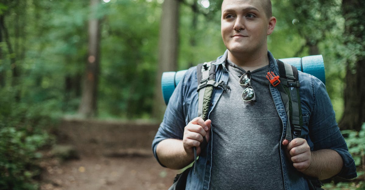 Is there a way to rename a discovery after you upload it? - Smiling plus size male backpacker standing on path in green dense forest during hiking