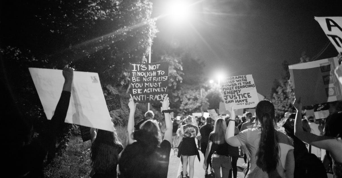 Is there a way to reset an island in Campaign mode? - Back view of black and white crowd of unrecognizable protesting people walking on street with banners during anti racism demonstration