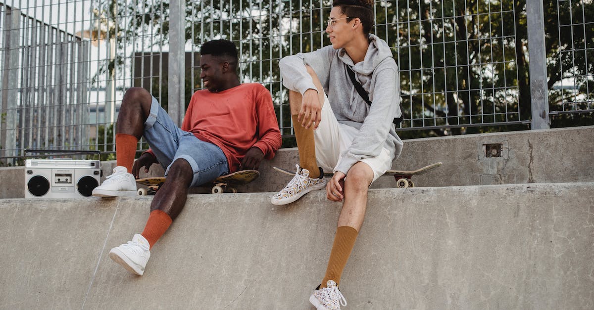 Is there a way to respec my skills? - Cheerful men with skateboards resting om ramp