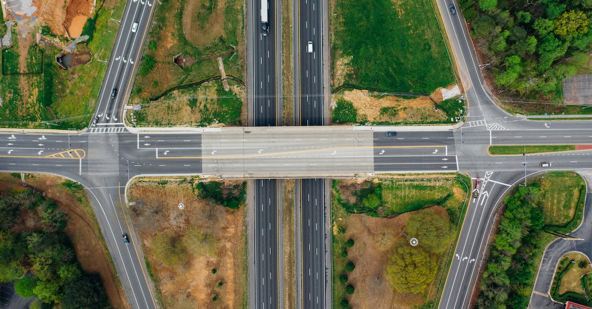 Is there a way to run Minecraft 1.7.9 from the command line, and connect to a server without seeing the launcher or main menu? - Highway junction with marking lines near green trees in suburb