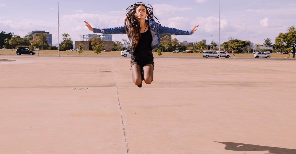 Is there a way to see previous Magikarp in Magikarp Jump? - Young female in denim jacket with dreadlocks jumping on city street in sunny day and looking at camera