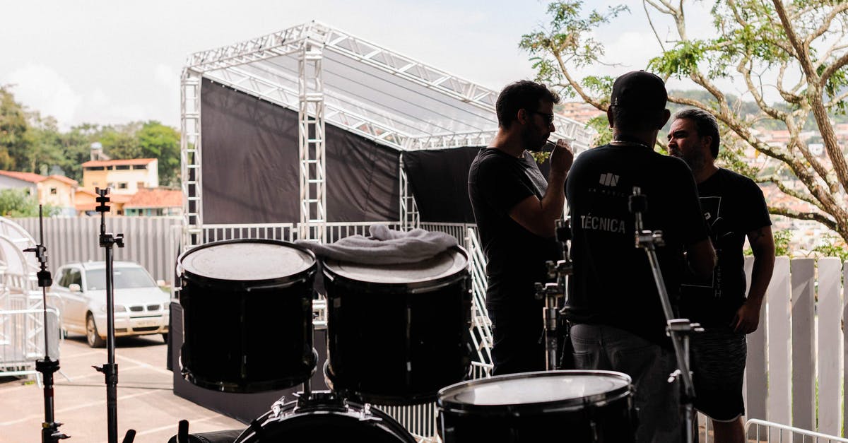Is there a way to set separate voice options for group channel and team channel? - Group of men on stage with drums
