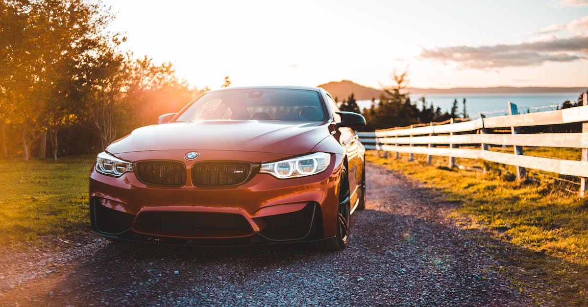 Is there a way to set the field of view (FOV) higher? - Red shiny car parked near fenced meadow and lake at sundown