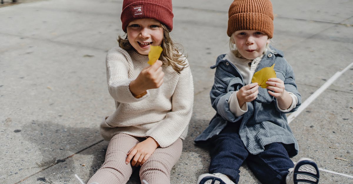 Is there a way to show mouse clicks on screen? - Happy siblings sitting on sidewalk with yellow leaves