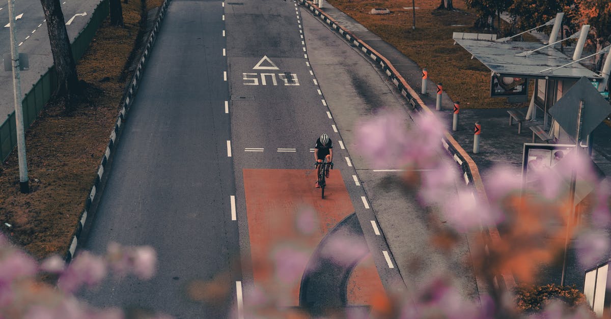 Is there a way to stop my helmet from destroying my skin in minecraft? - From above of cyclist in helmet riding on flat asphalt road in public transport lane