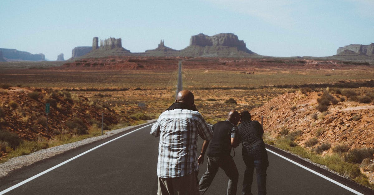 Is there a way to take picture outside would encounters? - Unrecognizable black men on asphalt road