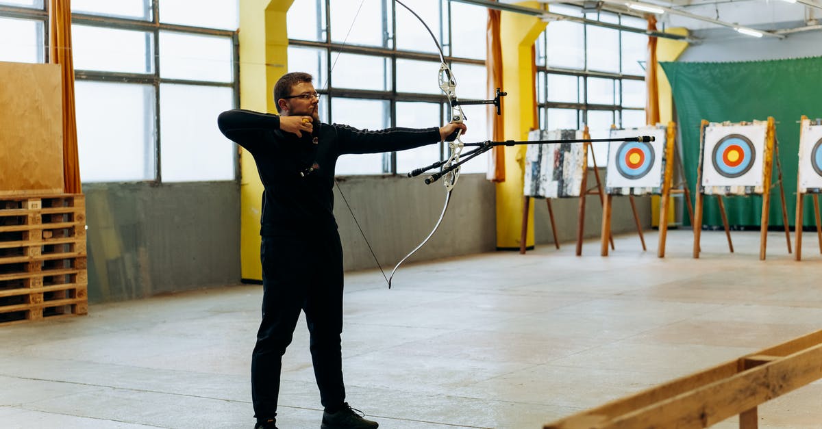 Is there a way to target the arrow from an OP bow via command block? - Man in Black Clothes Aiming Bow Is there a way to target the arrow from an OP bow via command block? - Man in Black Clothes Aiming Bow