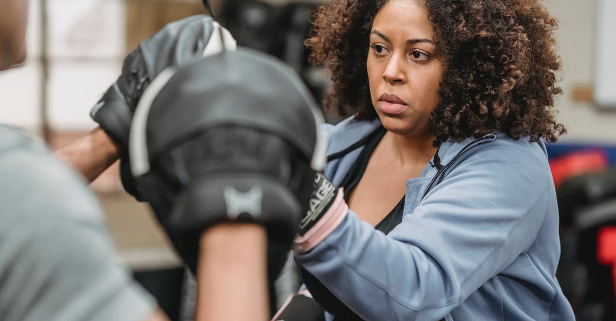 Is there a way to tell how much extra heal and shield power you have? - Serious black lady boxing in gym during training with male instructor
