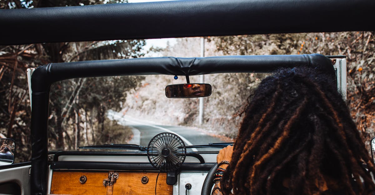 Is there a way to /tellraw the output of a command? - Back view of unrecognizable traveler with stylish dreadlocks spinning steering wheel while driving car and reflecting in small mirror