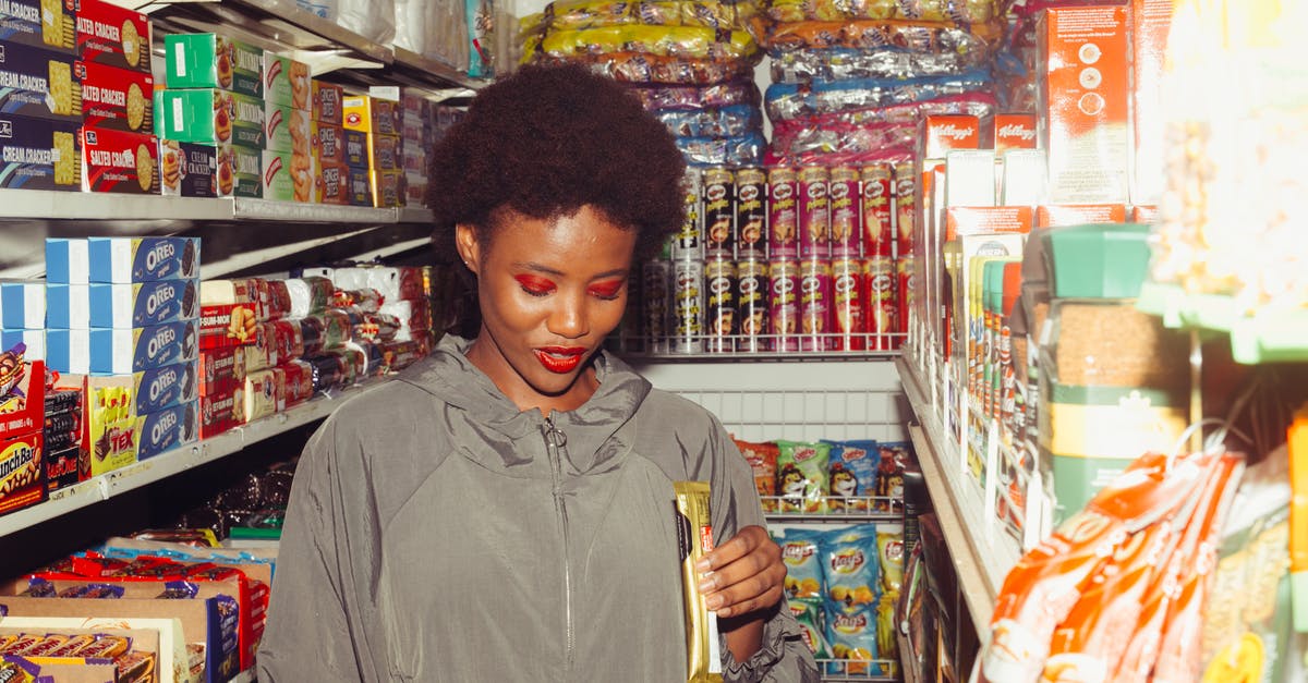 Is there a way to trade cities? - Positive ethnic woman choosing food in grocery store Is there a way to trade cities? - Positive ethnic woman choosing food in grocery store