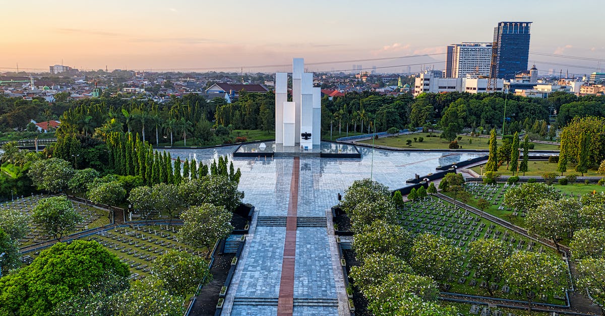 Is there a way to use an upgraded animation for a hero without buying it? - Narrow paved walkway leading to modern building located on national main heroes cemetery with tombstones and lush green trees in Kalibata