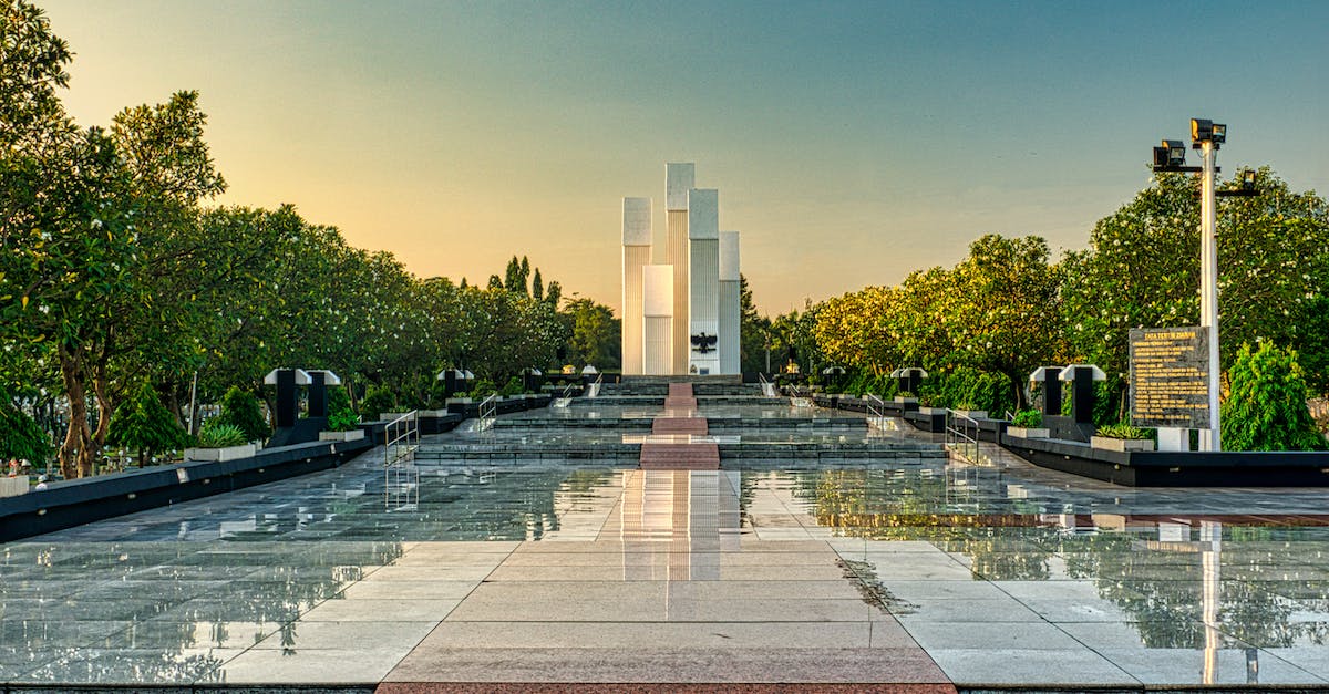 Is there a way to use an upgraded animation for a hero without buying it? - Granite pathway with steps among lush green trees leading to modern tall building in national main heroes cemetery in Kalibata