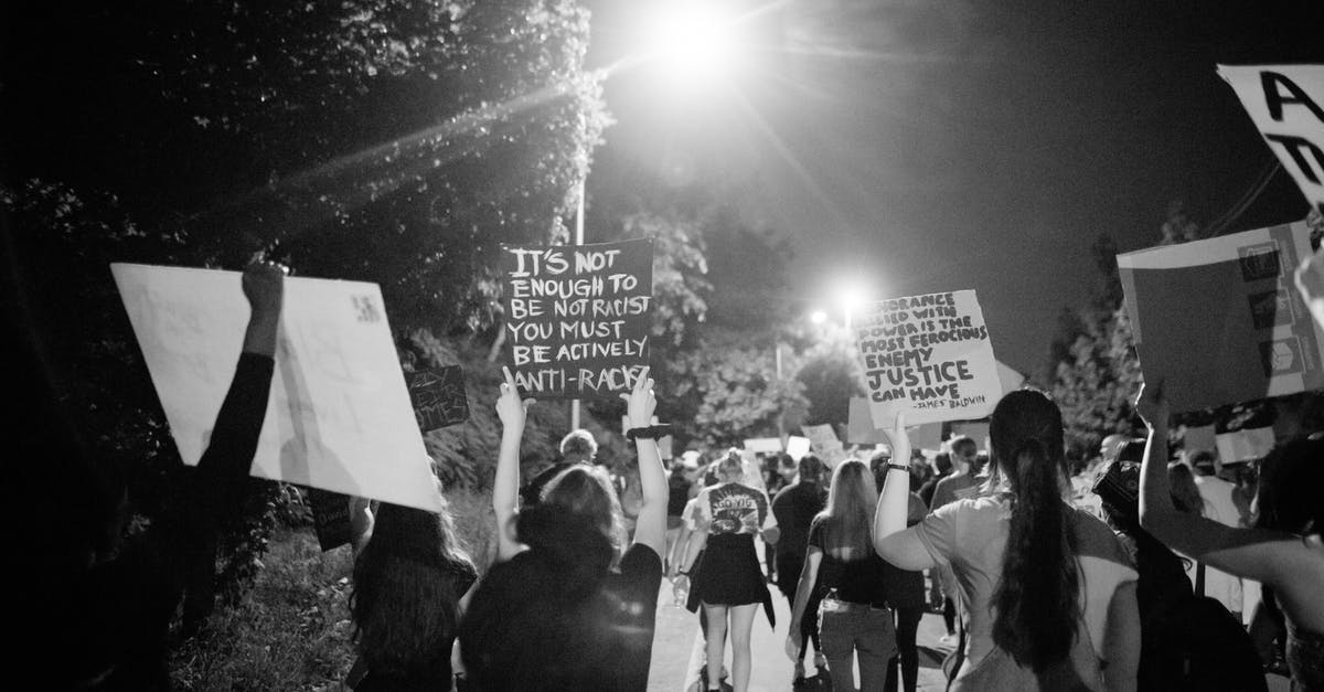 Is there a way to view your standings on Clash Royale global tournament? - Back view of black and white crowd of unrecognizable protesting people walking on street with banners during anti racism demonstration