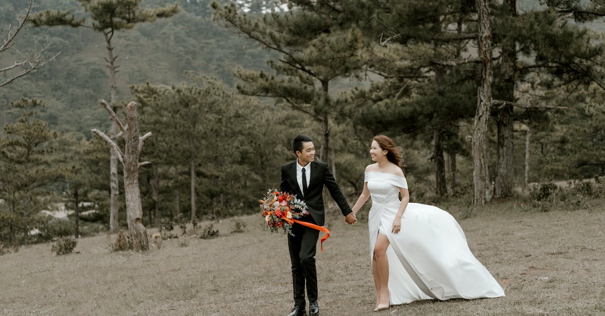 Is there a wood elf wife that you can marry? [duplicate] - Full body of newlywed married Asian couple in tuxedo and wedding dress walking in green coniferous woods