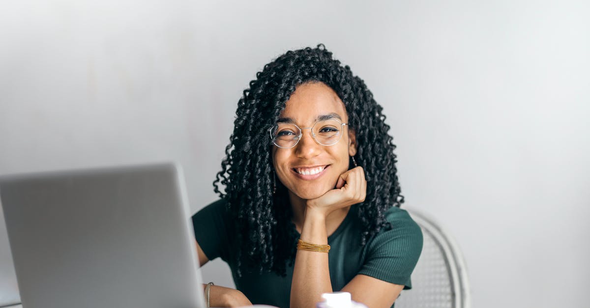 Is there adult content in A.W.: Phoenix Festa? - Happy ethnic woman sitting at table with laptop