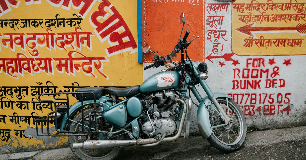 Is there an easy way to get out of a cave? - Old rusty motorcycle parked near shabby wall with various graffiti and inscriptions on city street Is there an easy way to get out of a cave? - Old rusty motorcycle parked near shabby wall with various graffiti and inscriptions on city street
