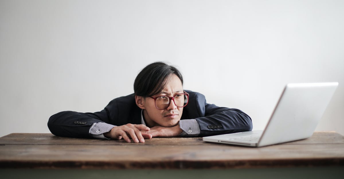 Is there an ideal time to use marketing? - Bored formal man watching laptop at desk Is there an ideal time to use marketing? - Bored formal man watching laptop at desk