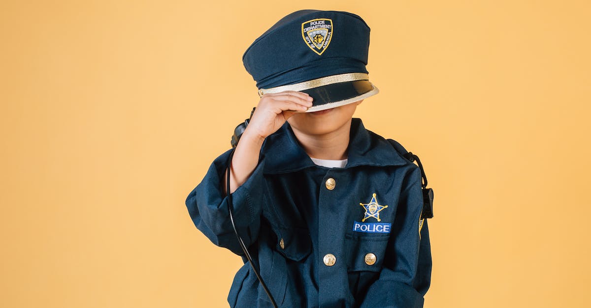 Is there an optimal order to play through? - Unrecognizable child in police uniform standing in studio with transceiver in hand and pulling cap over face on yellow background Is there an optimal order to play through? - Unrecognizable child in police uniform standing in studio with transceiver in hand and pulling cap over face on yellow background