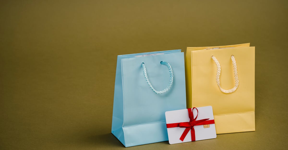 Is there an overview about the different rewards for the Card Mastery feature in Clash Royale? - Collection of bright present paper bags with natural handles near gift card with ribbon