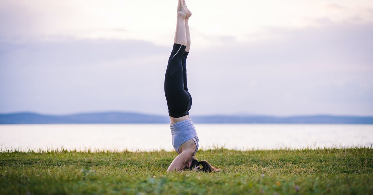 Is there any benefit of stretching out the kill shot? - Woman in Black Tank Top and Black Leggings Lying on Green Grass Field