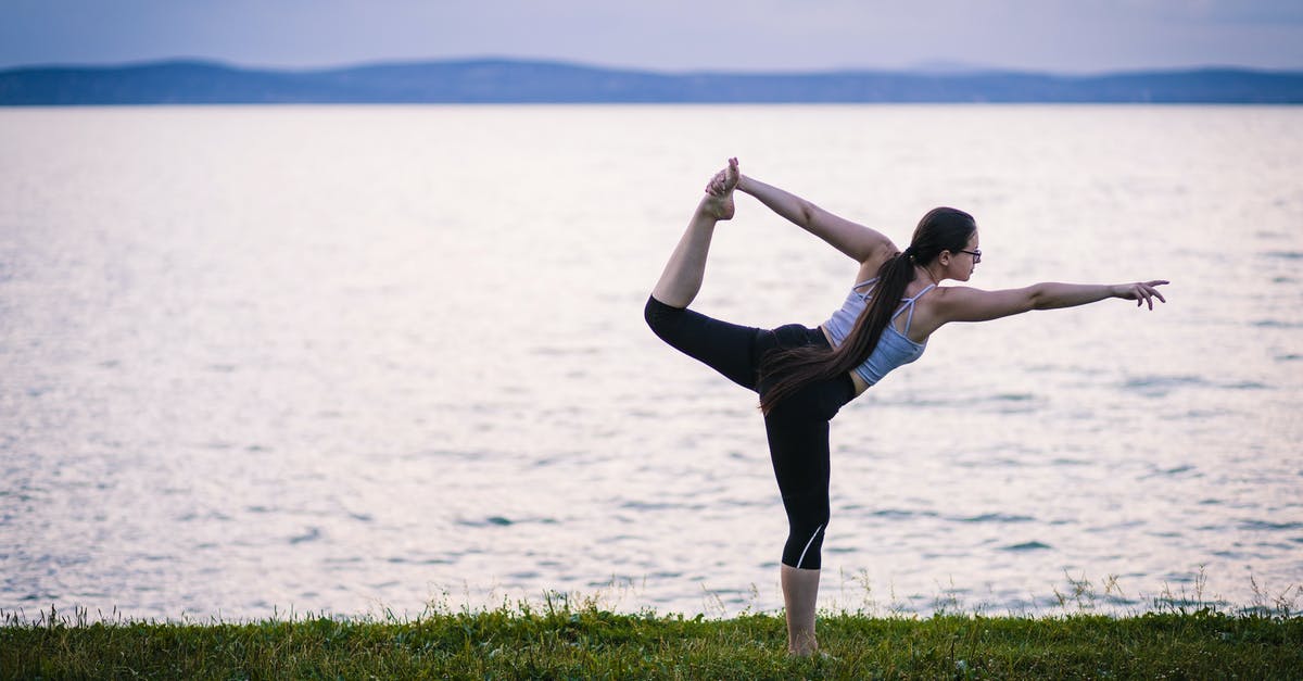 Is there any benefit of stretching out the kill shot? - Woman in Black Tank Top and Black Pants Jumping on Green Grass Field Near Body of during