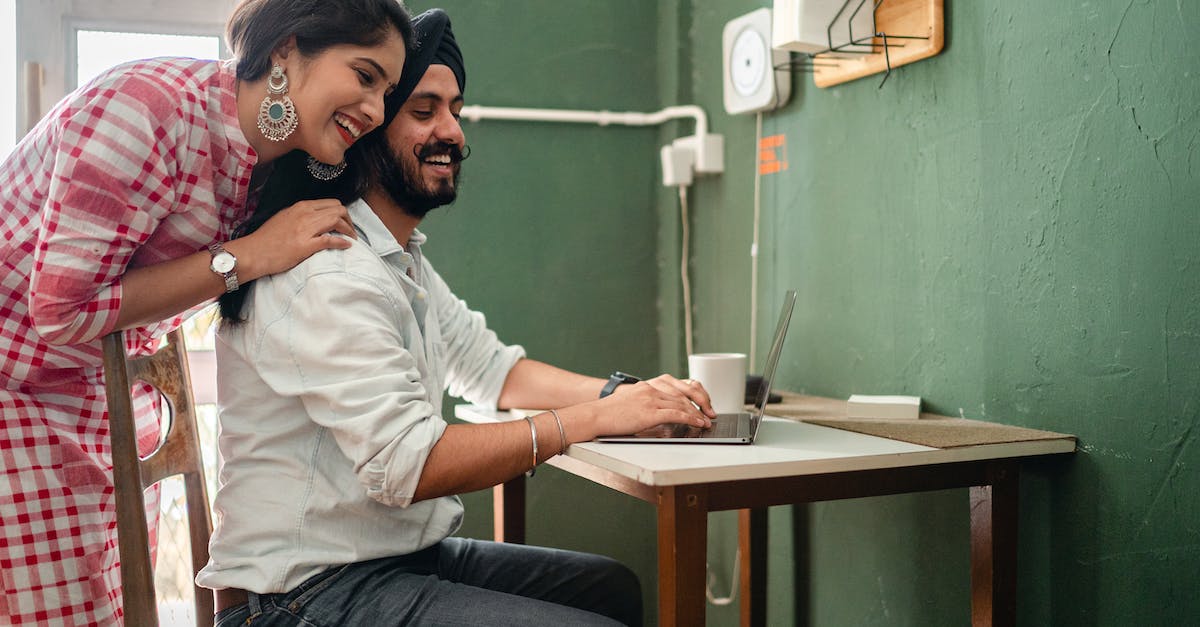 Is there any console that supports Java on their Internet browser? [closed] - Happy young cuddling Indian couple using laptop during work at home
