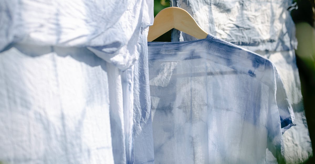 Is there any difference between spouses chores? - Collection of various washed clothes hanging on rope on fresh air on sunny day in summer Is there any difference between spouses chores? - Collection of various washed clothes hanging on rope on fresh air on sunny day in summer