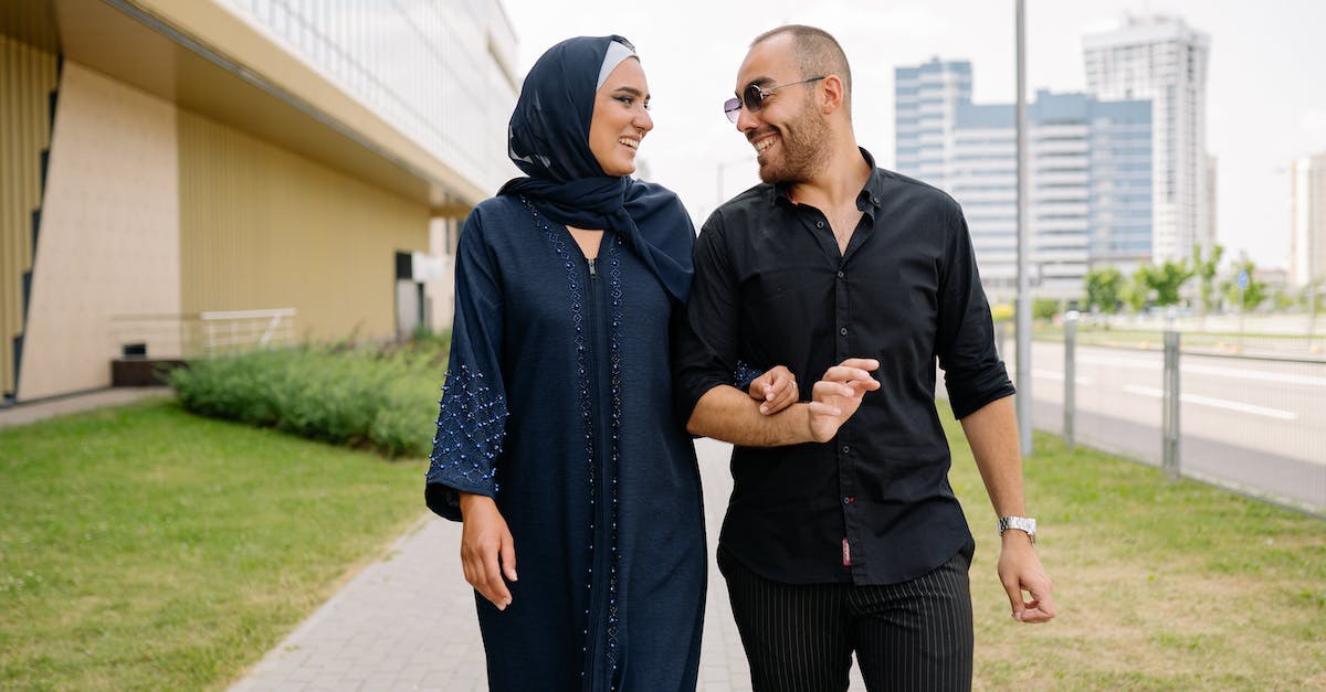 Is there any effect when placing buildings next to each other? - Couple Walking in Front of Building Looking at Each Other